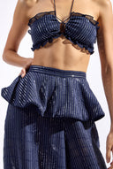 Model wearing the Sequin Peplum Maxi Pants detail color naby made from 100% polyester, styled for a dinner look