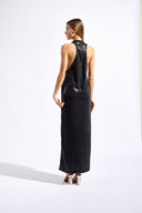 Model wearing the Sequin Plunge Maxi Dress back color black made with 96% Polyester 4% Elastane fabric, styled for a dinner look 