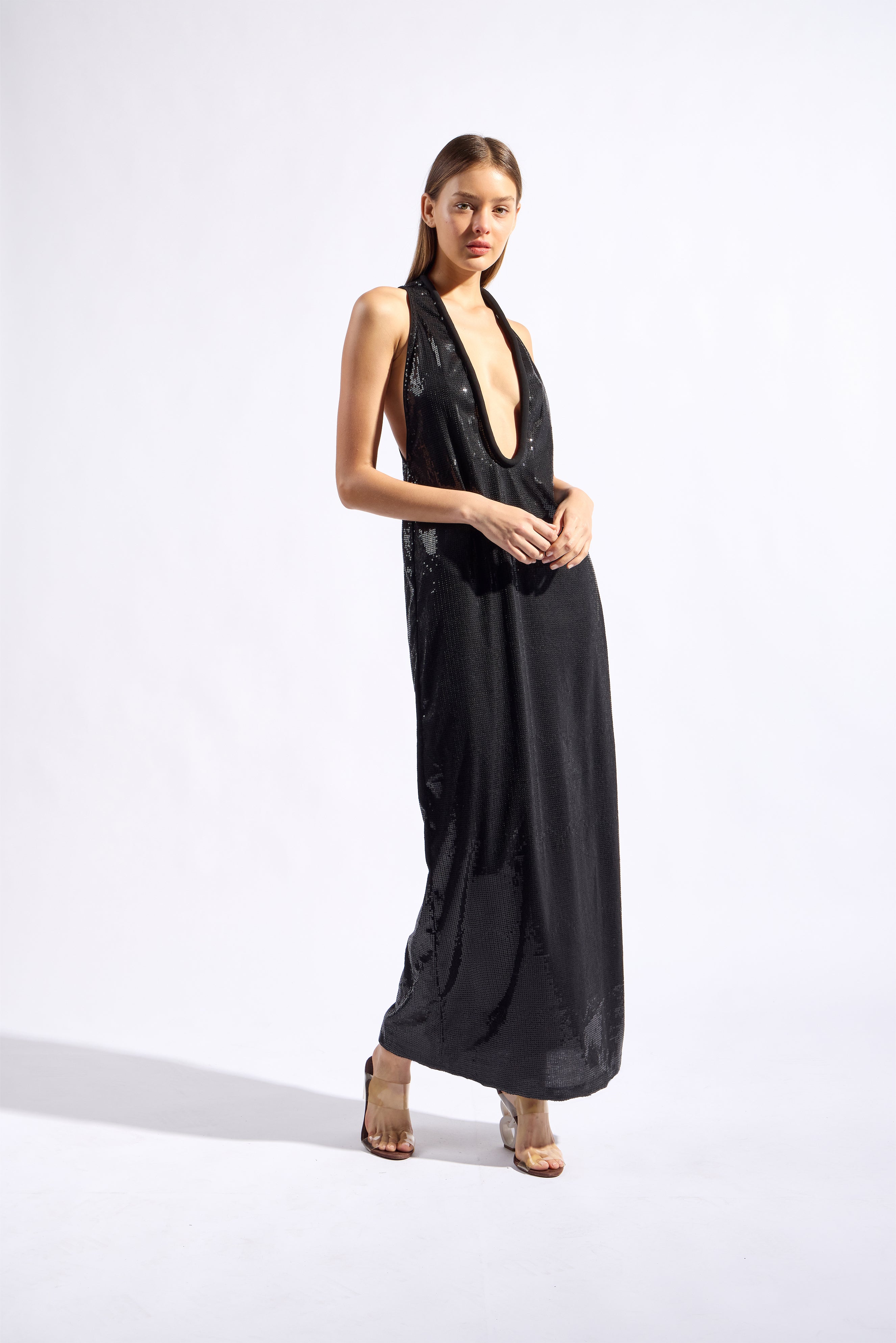 Model wearing the Sequin Plunge Maxi Dress front color black made with 96% Polyester 4% Elastane fabric, styled for a dinner look 