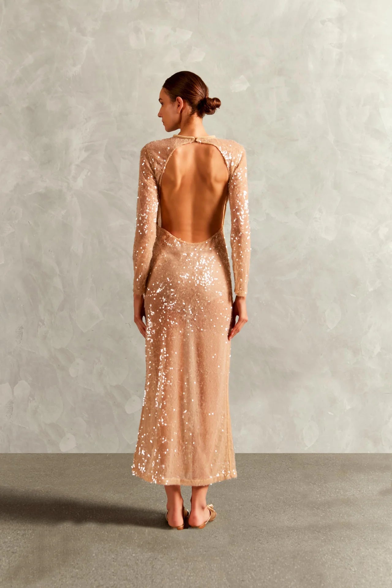 Model wearing the Sequins Open-Back Long Dress back with 100% polyester fabric styled for a dinner look