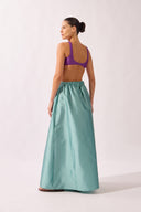 Model wearing the Side-Slit Maxi Skirt back color aquamarine made with 100% polyetser, styled for an post-beach look