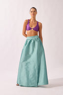Model wearing the Side-Slit Maxi Skirt front color aquamarine made with 100% polyetser, styled for an post-beach look