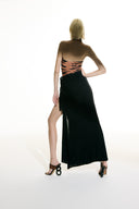 Model wearing the Side-Tie Maxi Skirt black back from the Adriana Degreas and Sabine Getty collab with 100% Silk styled for a casual look.