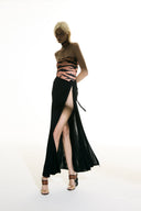 Model wearing the Side-Tie Maxi Skirt black front from the Adriana Degreas and Sabine Getty collab with 100% Silk styled for a casual look.