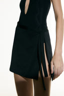 Model wearing the  Side-Tie Sheer Mini Skirt black detail from the Adriana Degreas and Sabine Getty collab with 100% Silk styled for a party look. 