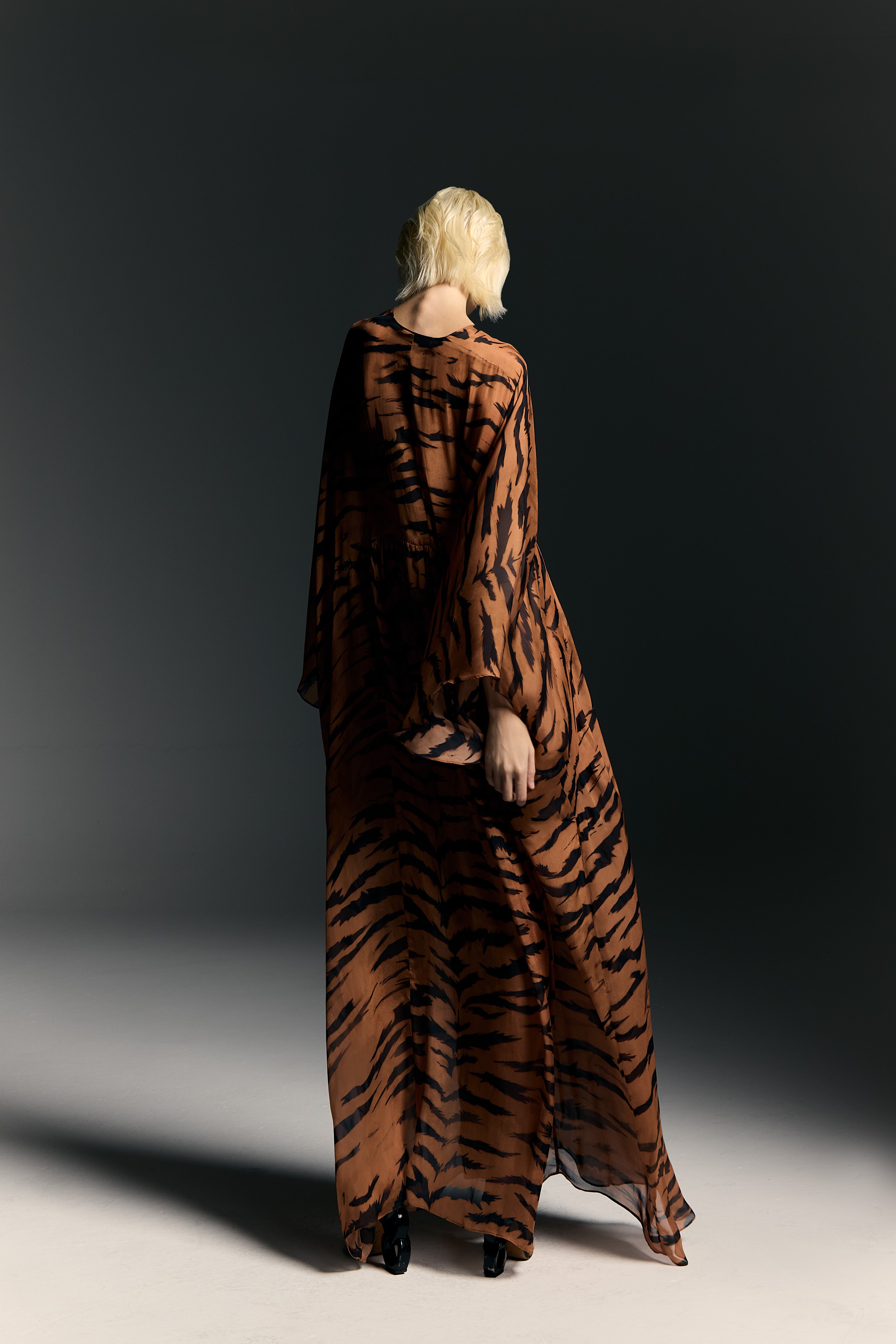 Model wearing the Silk Maxi Kaftan back from the Adriana Degreas and Sabine Getty collab with 100% Silk styled for an evening look.