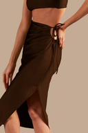 Model wearing the Solid AD Frilled Midi Skirt Front showcasing its Coffee print on 85% polyamide 15% elastane fabric, styled for a post-beach look.