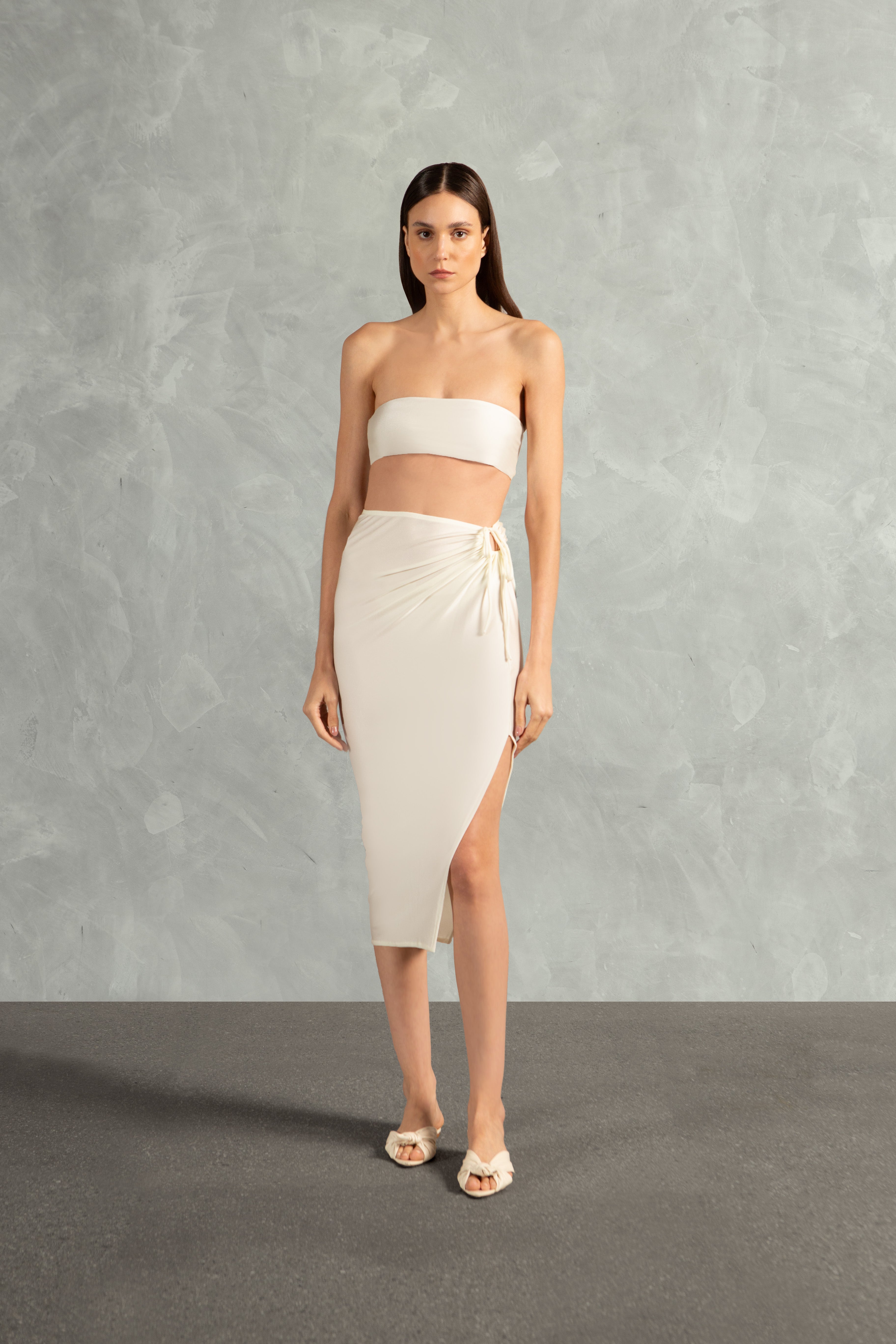 Model wearing the Solid AD Frilled Midi Skirt Front showcasing its Off White print on 85% polyamide 15% elastane fabric, styled for a post-beach look.