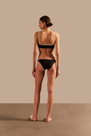 Model wearing the Solid AD Straps Bikini Back showcasing its Black and Off White color on 85% polyamide 15% elastane fabric.