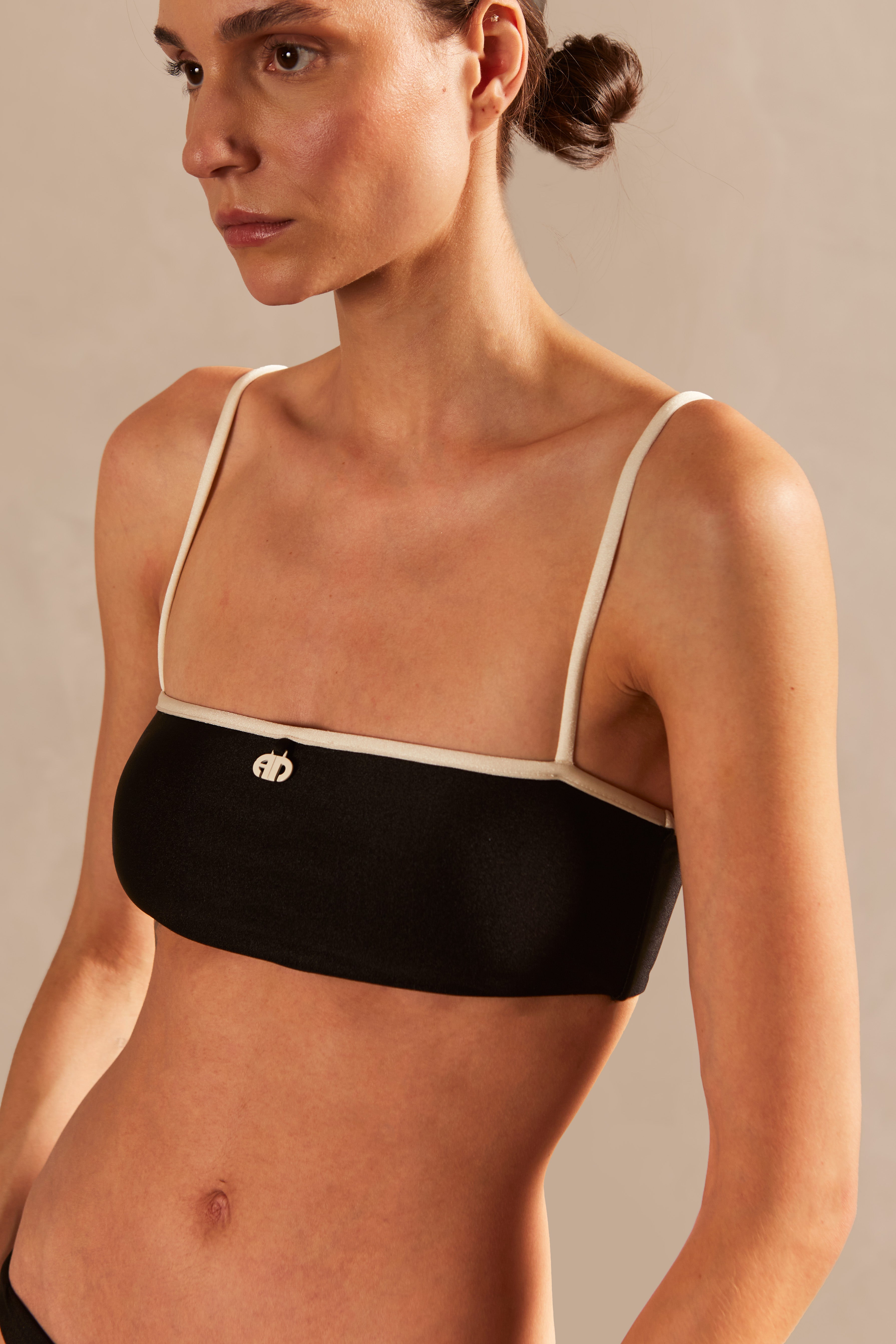 Model wearing the Solid AD Straps Bikini Detail showcasing its Black and Off White color on 85% polyamide 15% elastane fabric.