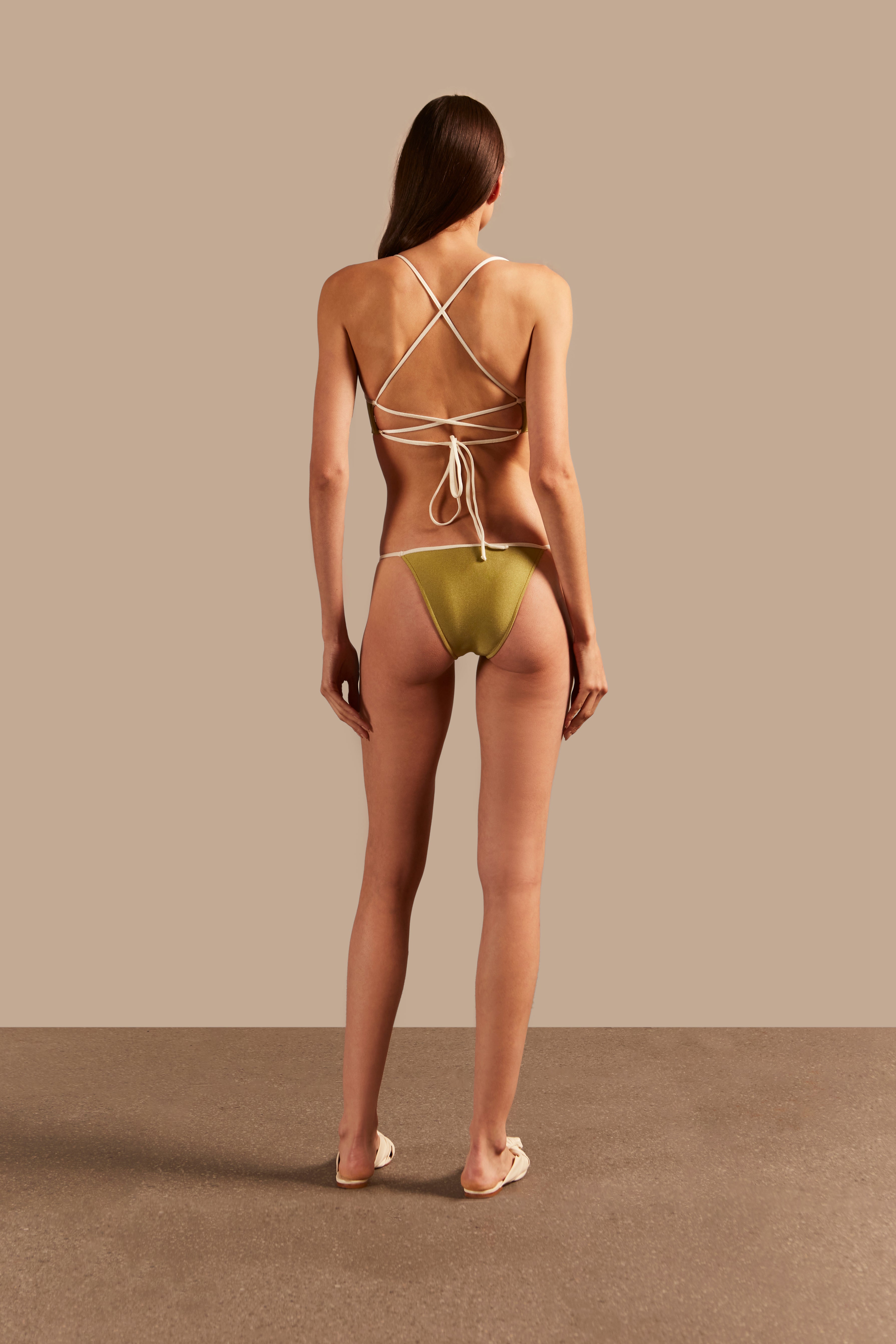 Model wearing the Solid AD Straps Bikini Back showcasing its classic references with Pistachio print on 85% polyamide 15% elastane fabric, styled for a beachwear look.