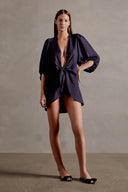 Model wearing the Solid Shirt With Voluminous Sleeves color dark blue front with 100% linen fabric, styled for a resort look. 