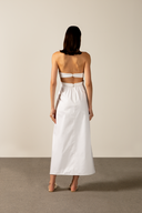 Model wearing the Solid Cut-Out Halterneck Long Dress Back showcasing its classic references with Off White print on 97% Cotton 03% Elastane fabric, styled for an afternoon look.