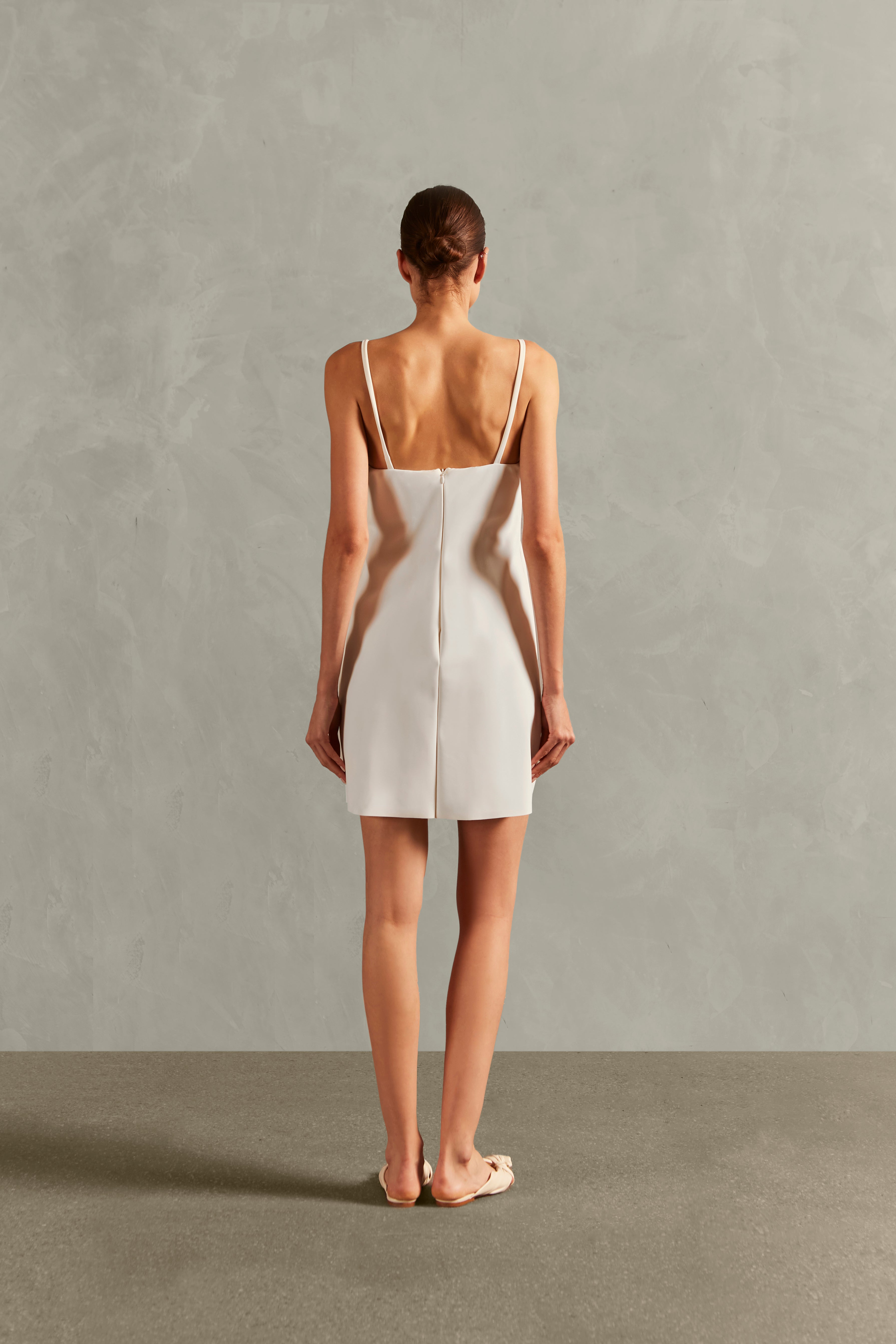 Model wearing the Solid Deep-V Midi Dress Back showcasing its White color on 76,3% Polyamide 23,7% Elastane fabric.   