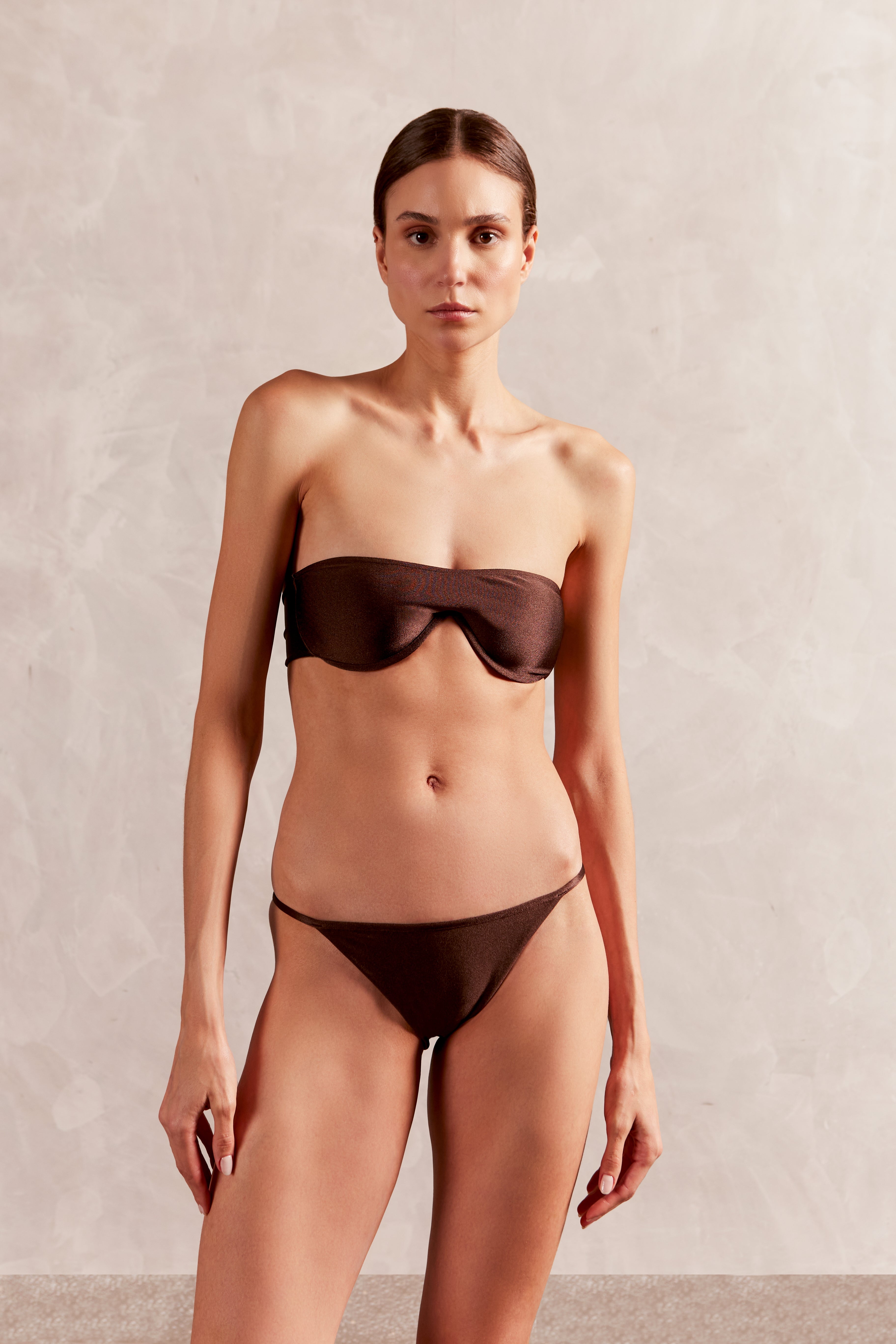 Model wearing the Solid Giardino Sunglasses Bikini Front showcasing its coffee color on a stretchy fabric, stled for a beachwear look.