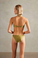 Model wearing the Solid Hoops Strapless Bikini showcasing the back of it's halterneck green pistachio top and low waisted bottom, on a stretchy fabric. 