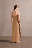 Model wearing the Solid Cut-Out Long Dress Back showcasing its Beige print on 98% Cotton 2% Spandex fabric, styled for an afternoon look.