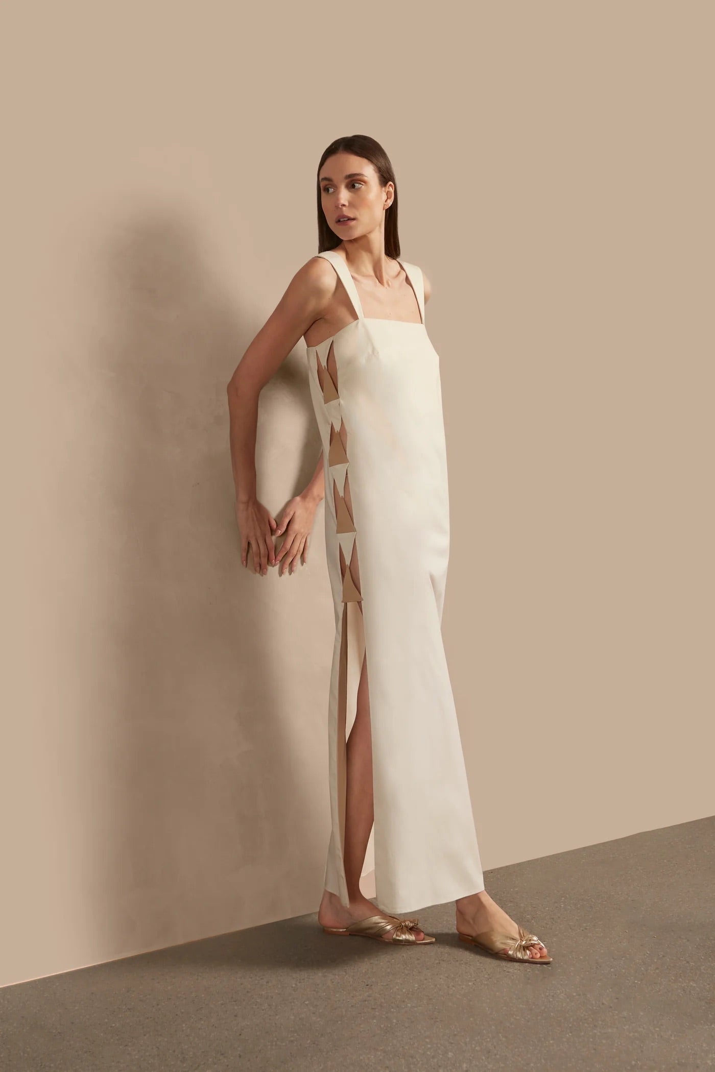 Model wearing the Solid Cut-Out Long Dress Front showcasing its Off White print on 98% Cotton 2% Spandex fabric, styled for an afternoon look.