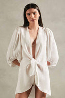 Model wearing the Solid Shirt With Voluminous Sleeves color off white front with 100% linen fabric, styled for a resort look. 
