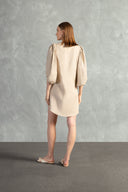 Model wearing the Solid Shirt With Voluminous Sleeves color sand back with 100% linen fabric, styled for a resort look. 