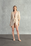 Model wearing the Solid Shirt With Voluminous Sleeves color sand front with 100% linen fabric, styled for a resort look. 