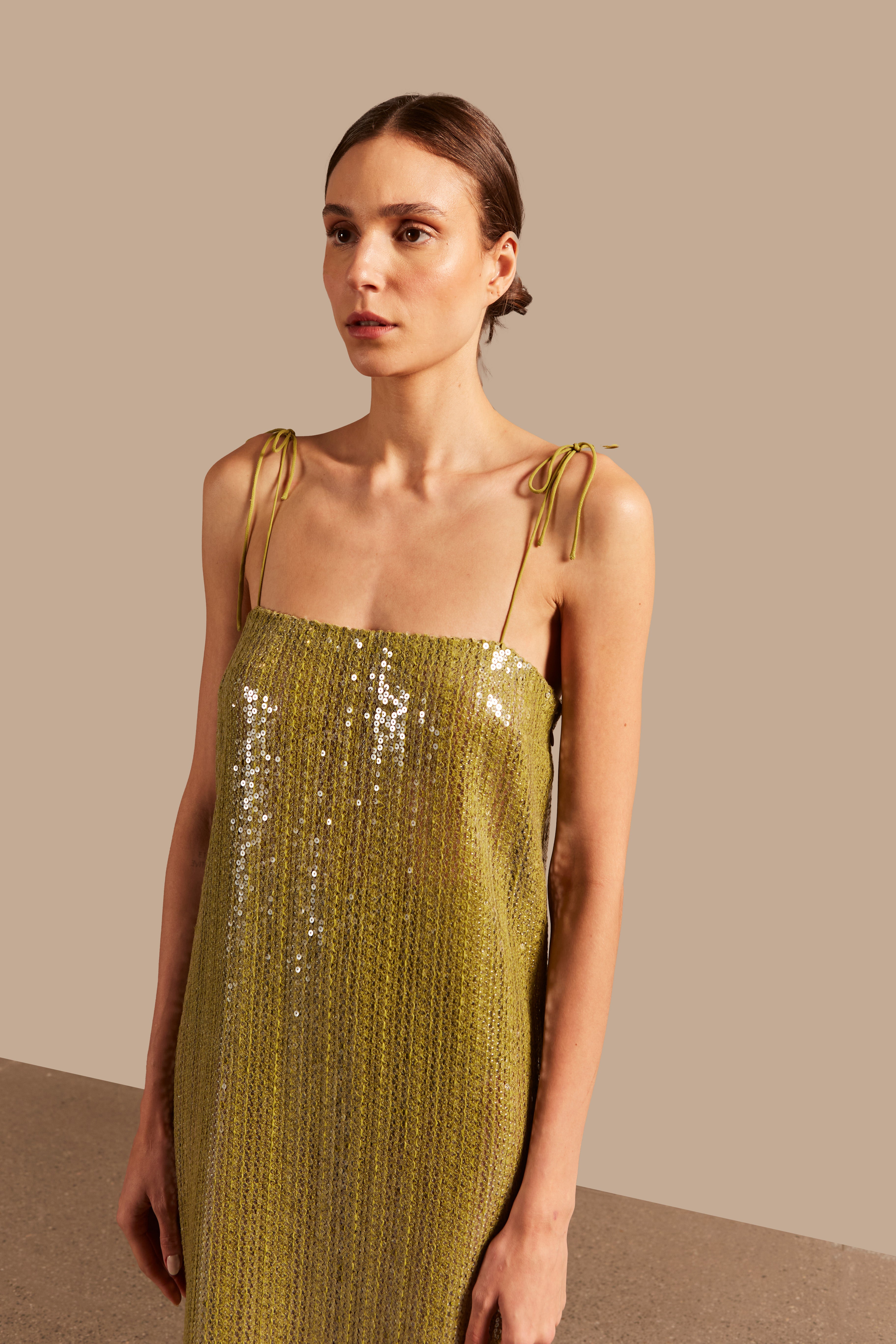 Model wearing the Solid Sequins Midi Dress Close showcasing its Pistachio print on 85% Polyester 15% Cotton fabric, styled for a night look.