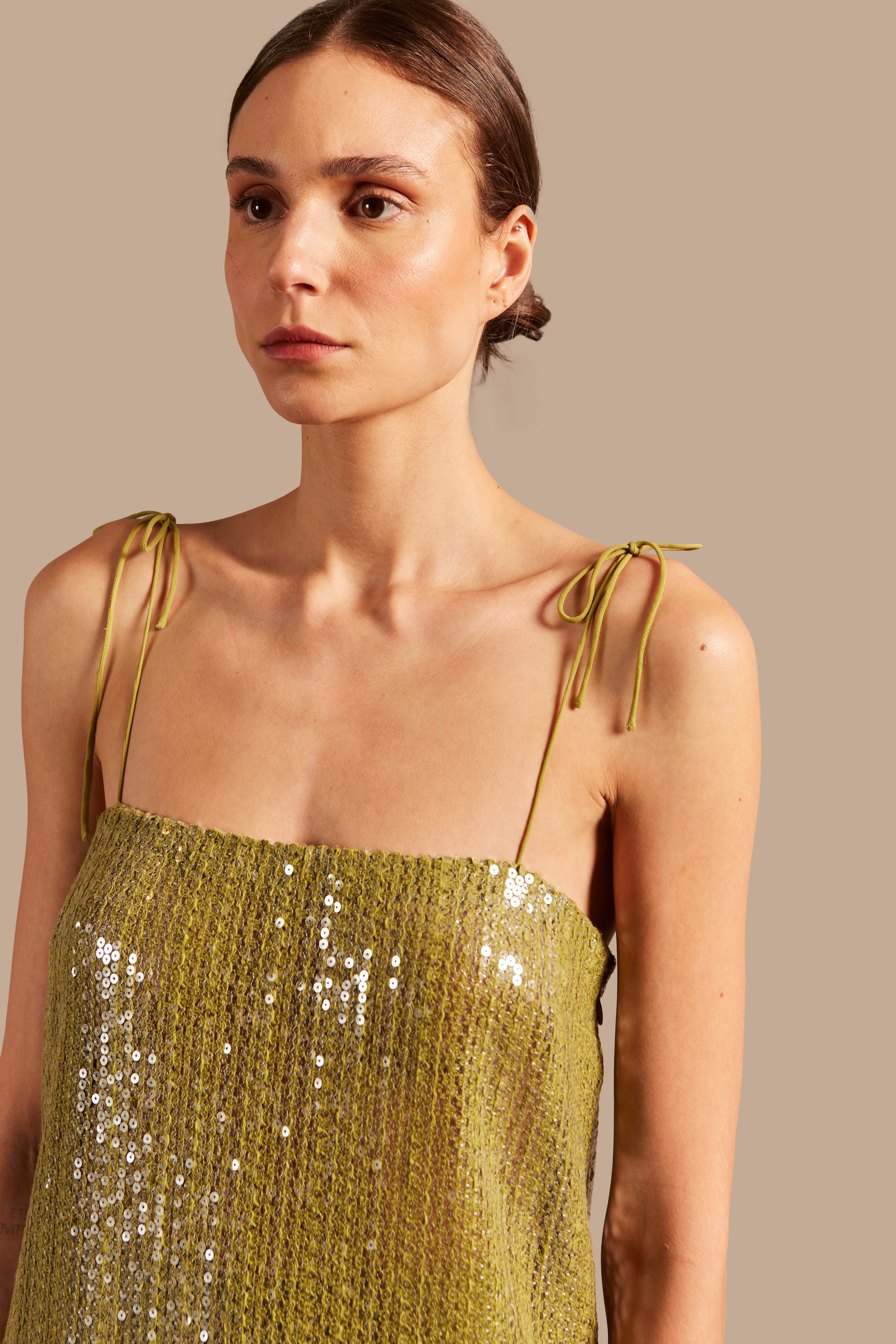 Model wearing theSolid Sequins Midi Dress Detail showcasing its Pistachio print on 85% Polyester 15% Cotton fabric, styled for a night look.