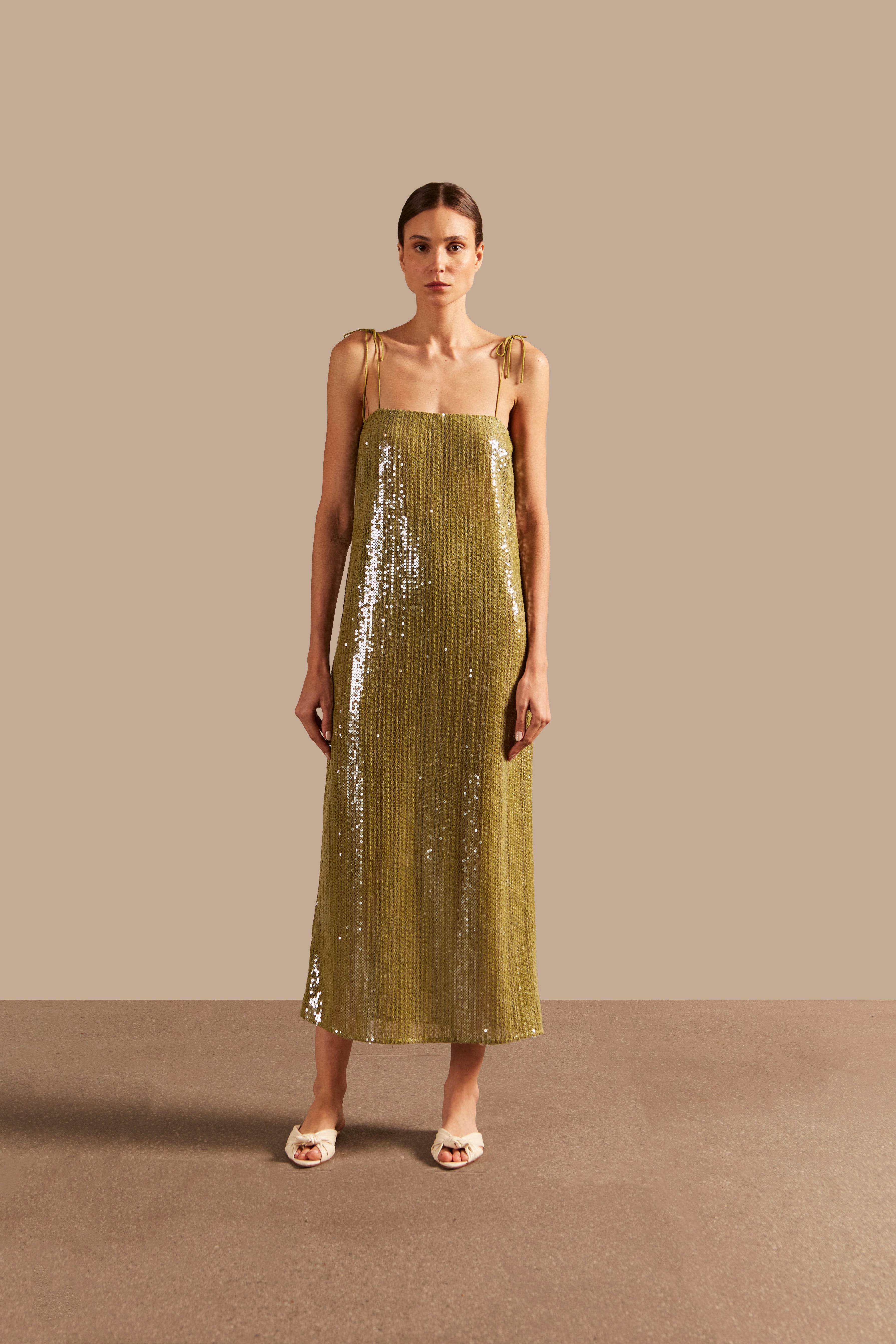 Model wearing theSolid Sequins Midi Dress Front showcasing its Pistachio print on 85% Polyester 15% Cotton fabric, styled for a night look.