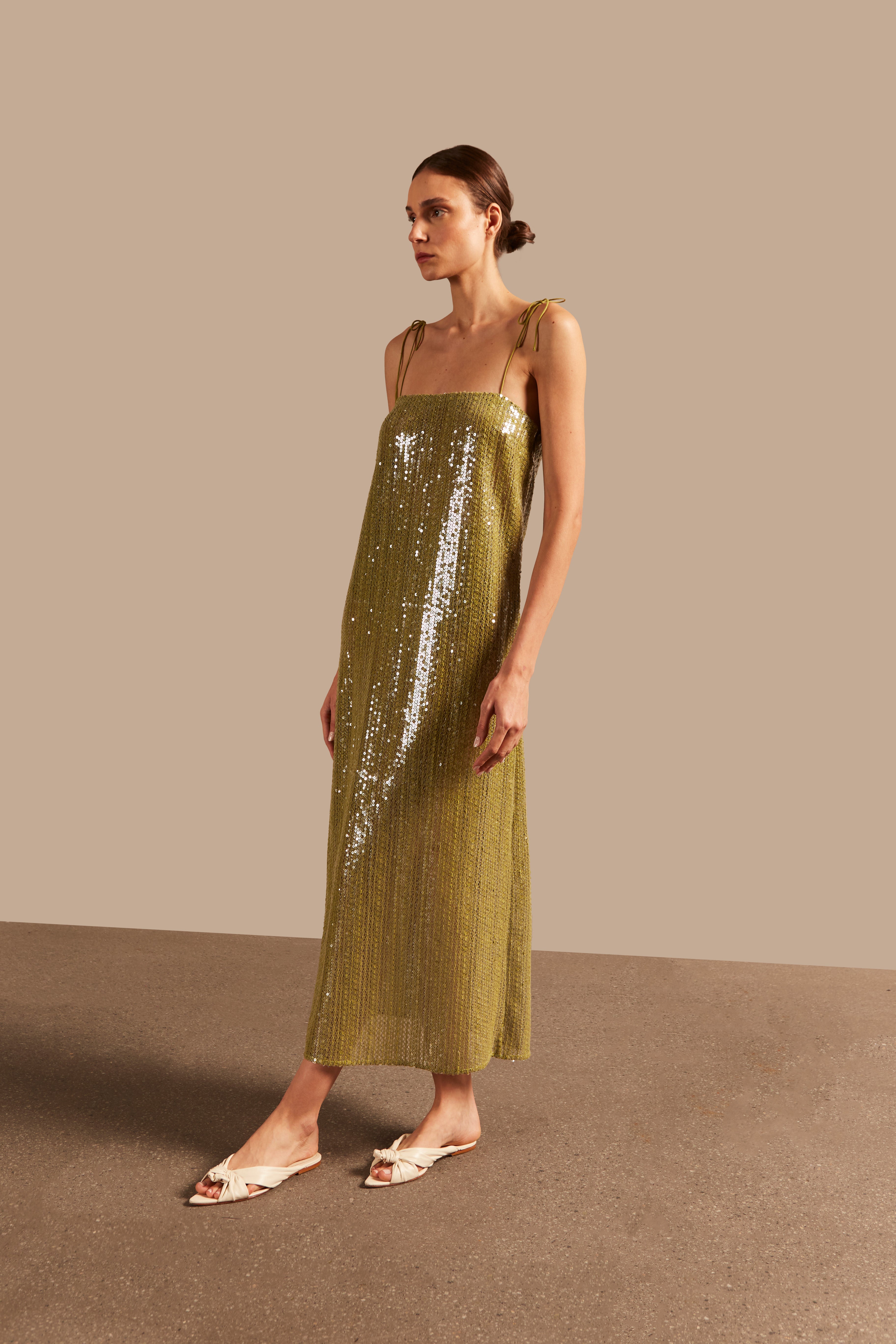 Model wearing the Solid Sequins Midi Dress Side showcasing its Pistachio print on 85% Polyester 15% Cotton fabric, styled for a night look.