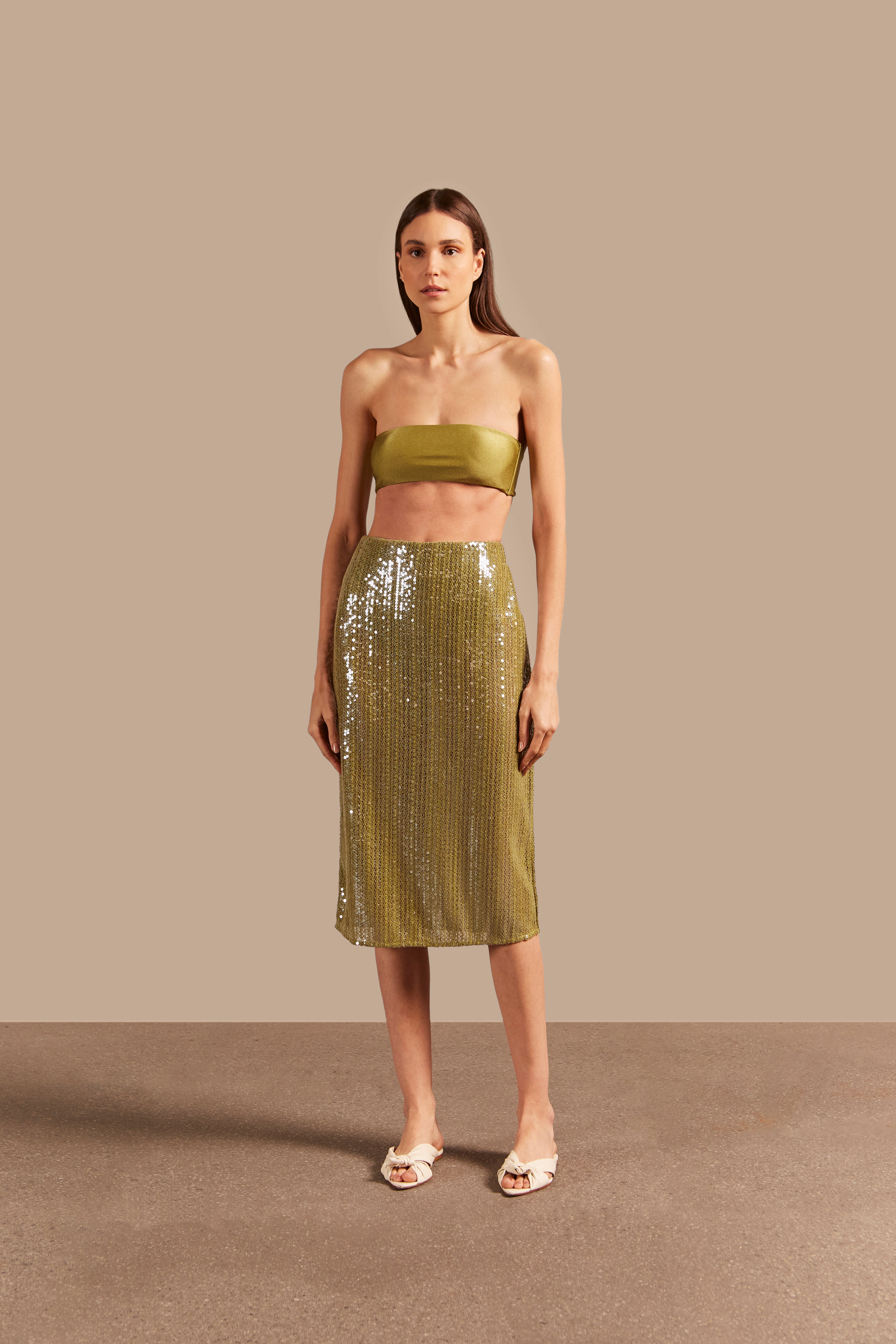 Model wearing the Solid Sequins Midi Skirt Front showcasing its Pistachio print on 85% Polyester 15% Cotton fabric, styled with strapless top for a casual look.
