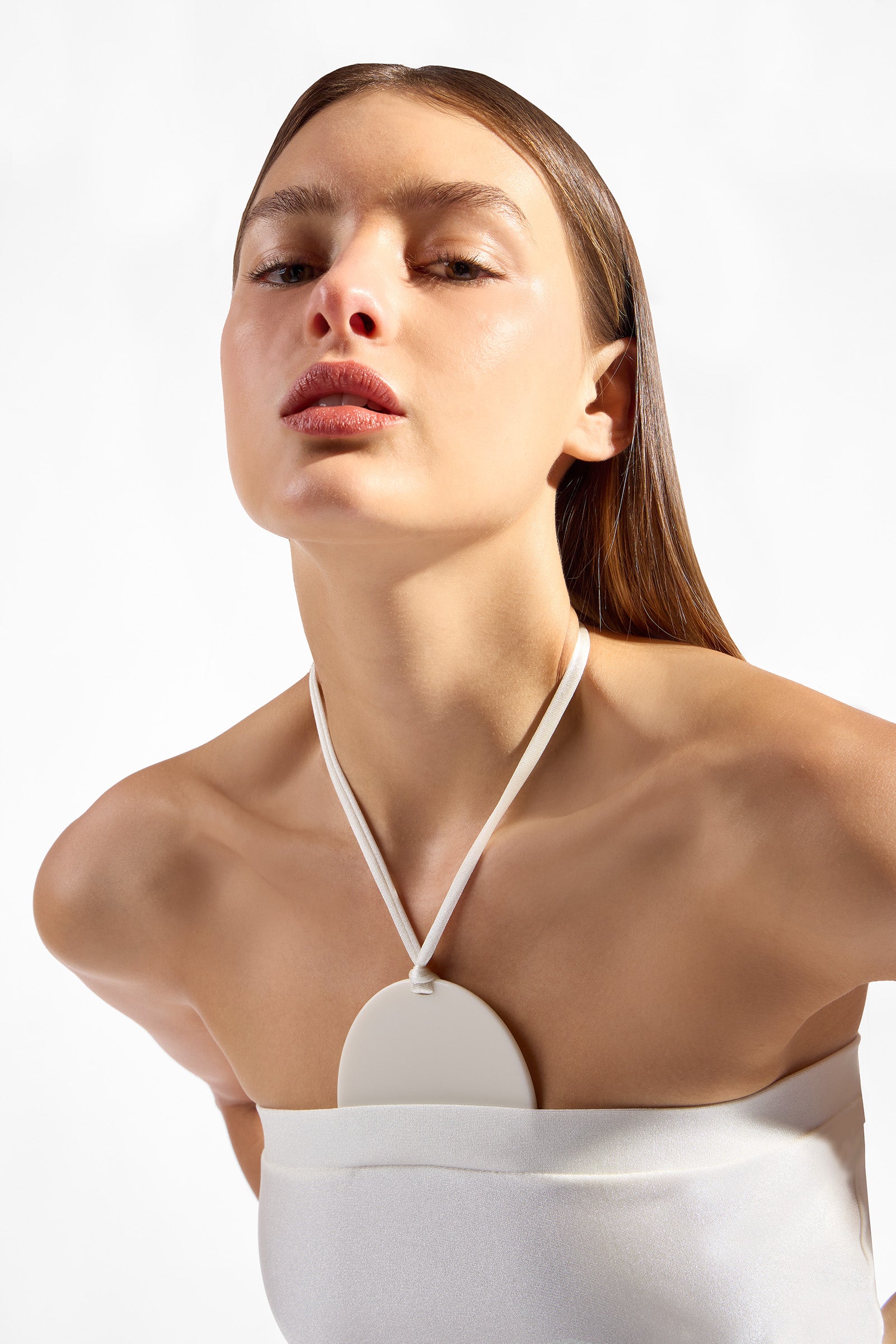 Model wearing the  Solid Appliqué Swimsuit detail color off white with 85% Polyamide 15% Elastane styled for a beachwear look