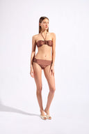 Model wearing the Solid Bandeau Bikini color cappuccino, styled for a beach look