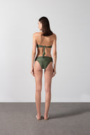 Model wearing the Solid Bandeau Bikini color croco green back, styled for a beach look