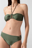 Model wearing the Solid Bandeau Bikini color croco green detail, styled for a beach look
