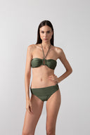 Model wearing the Solid Bandeau Bikini color croco green, styled for a beach look