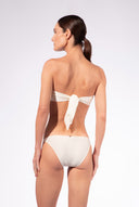 Model wearing the Solid Bandeau Bikini back color off white made from 85% plyamide 15% elastane, styled for a beachwear look