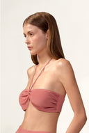 Model wearing the Solid Bandeau Top detail color vintage rose, made with 100% viscose fabric, styled for resortwear look 