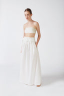 Model wearing the Solid Belted Long Skirt color off white styled for a resort look.