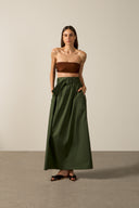Model wearing the Solid Belted Long Skirt color dark green styled for a resort look.