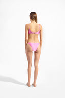 Model wearing the Solid Chain Bikini back color pink made from 85% polyamide 15% Elastane fabric, styled for a beachwear look