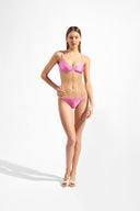 Model wearing the Solid Chain Bikini color pink made from 85% polyamide 15% Elastane fabric, styled for a beachwear look