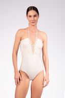 Model wearing the Solid Chain Halterneck Swimsuit color off white made from 85% polyamide 15% elastane, styled for a beachwear look