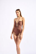 Model wearing the Solid Chain Halterneck Swimsuit look color cappuccino made from 85% polyamide 15% elastane, styled for a beachwear look