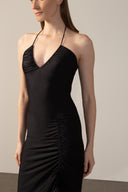 Model wearing the Solid Frilled Midi Dress detail color black made from 85% polyamide 15% elastane, styled for a dinner look