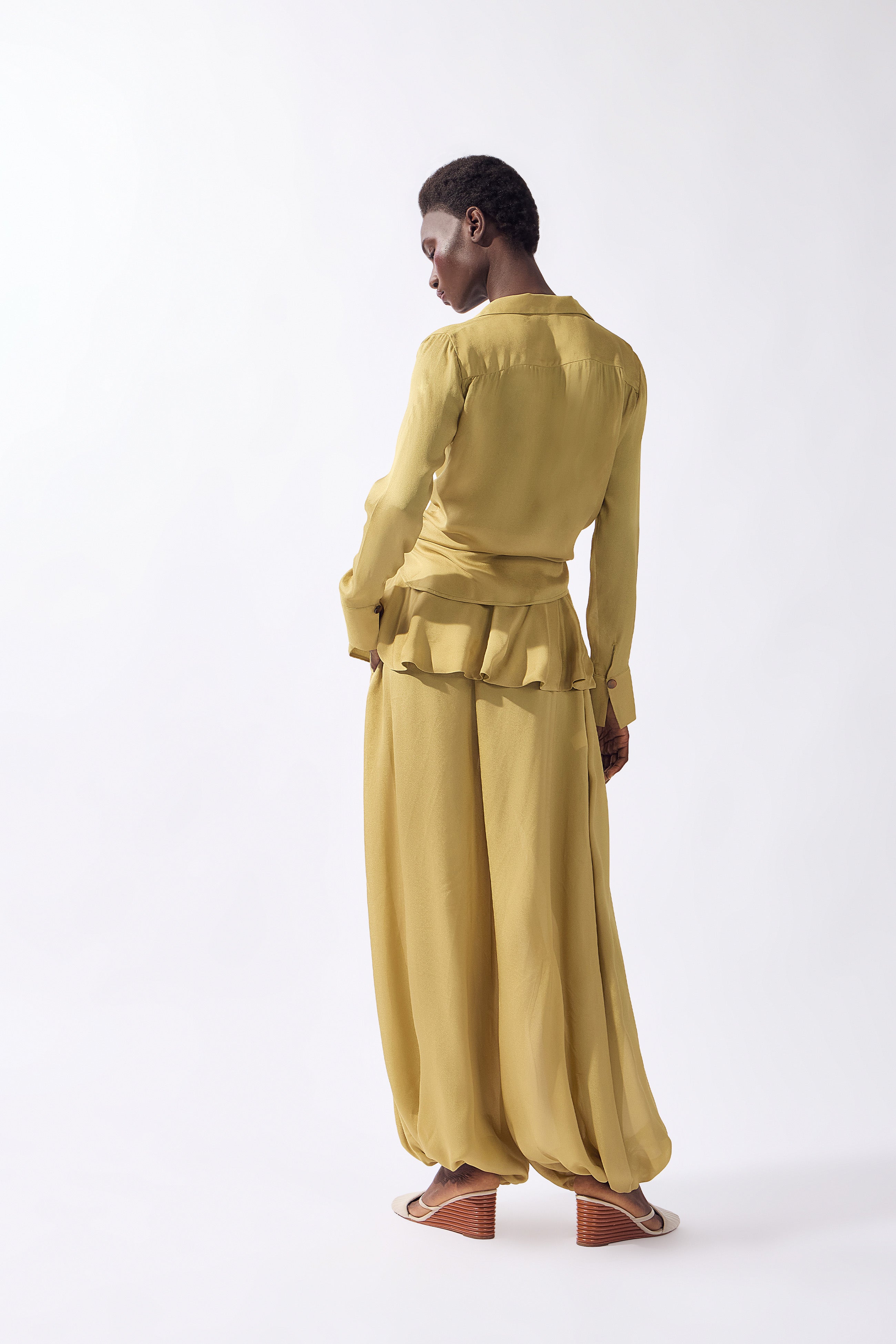 Model wearing the Solid Front-Tie Shirt back color pistachio, made from 100% viscose, styled for a dinner look