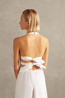 Model wearing the Solid Halter Long Dress off white detail with 100% viscose, styled for a resort look.