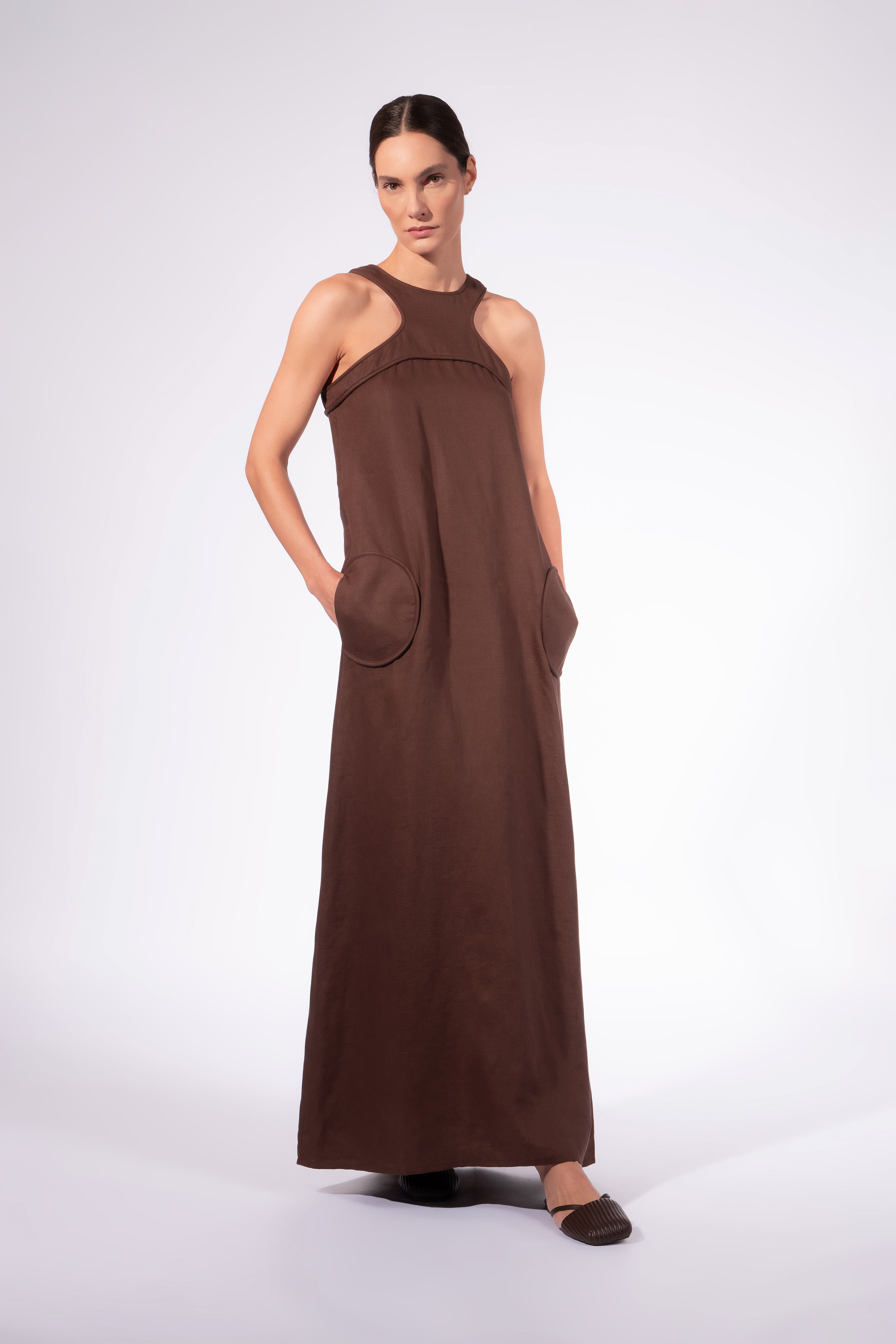 Model waering the Solid Maxi Dress front, showcasing its cocoa 100% viscose fabric, styled for a resort look.