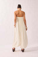 Model waering the Solid Maxi Jampsuit back, showcasing its off-white 70% Viscose 17% Polyamide 13% Linen fabric, styled for a resort look.