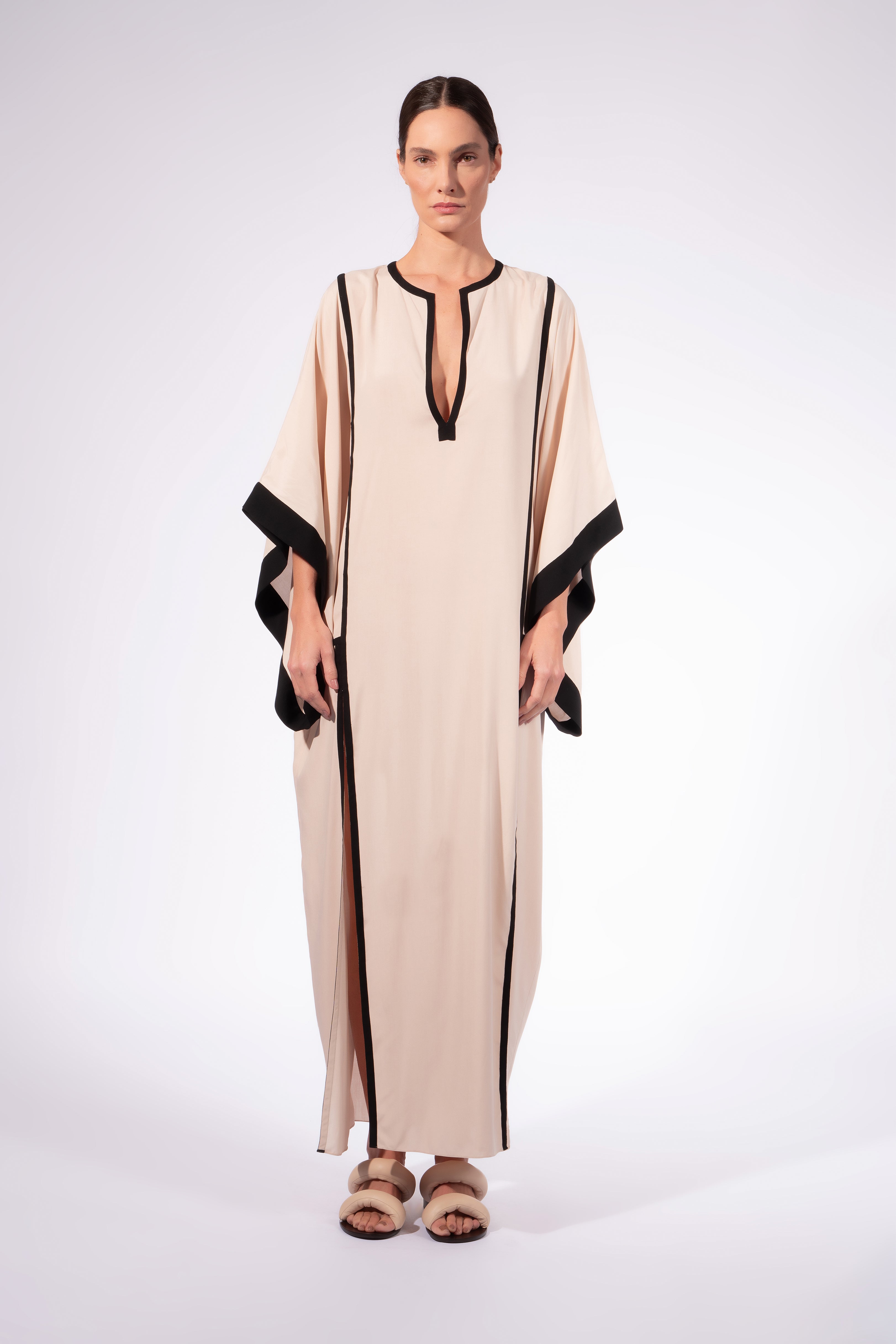 Model waering the Solid Maxi Kaftan front, showcasing its off-white 100% viscose fabric, styled for a resort look.
