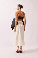 Model wearing the Solid Maxi Skirt back color off white, made from 92% polyester 07% elastane, styled for a dinner look